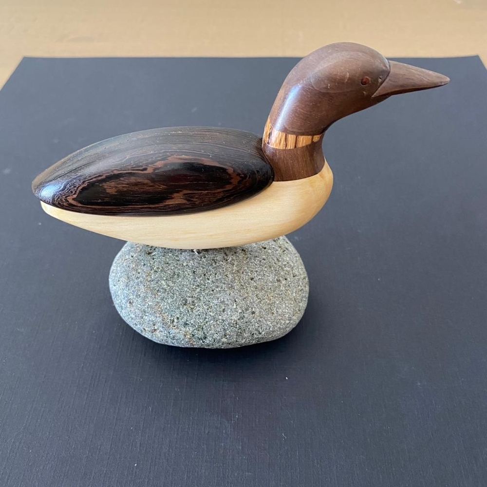 Cute Wooden Duck Sitting On A Stone Figurine